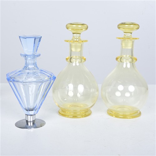 A PAIR OF COLOURED GLASS DECANTERS AND A CHROME AND GLASS DECANTER MADE IN CZECHOSLOVAKIA (25H X 12W CM)