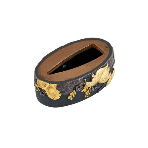 92 · A BRONZE, GILT, AND SHAKUDO RELIEF DECORATED JAPANESE SWORD FITTING (FUCHI)
