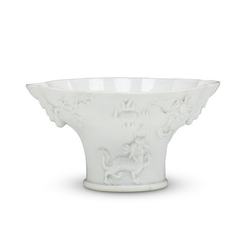 13 · A FINE AND LARGE CHINESE DEHUA BLANC-DE-CHINE LIBATION CUP WITH A DRAGON, A QILIN, A TIGER AND A CRANE, 18TH CENTURY