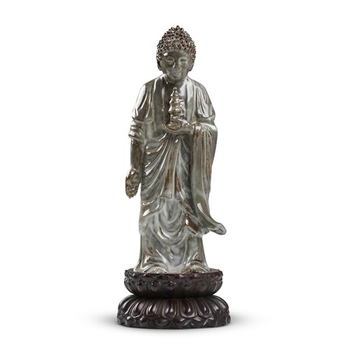 A FINE AND RARE YIXING ZISHA 'MOON-WHITE' GLAZED FIGURE OF SHAKYAMUNI, LATE MING DYNASTY, 17TH CENTURY