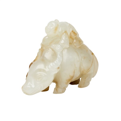 35 · A CHINESE WHITE AND RUSSET JADE CARVED BOY ON A BUFFALO, QING DYNASTY (1644 - 1911)