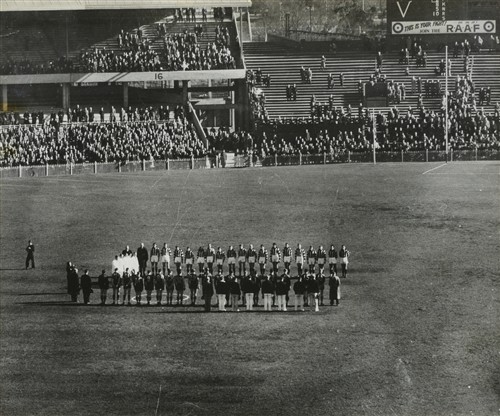 1057 · A PHOTOGRAPH OF 'THE LAST POST' BEING PLAYED AT THE MCG, 1941