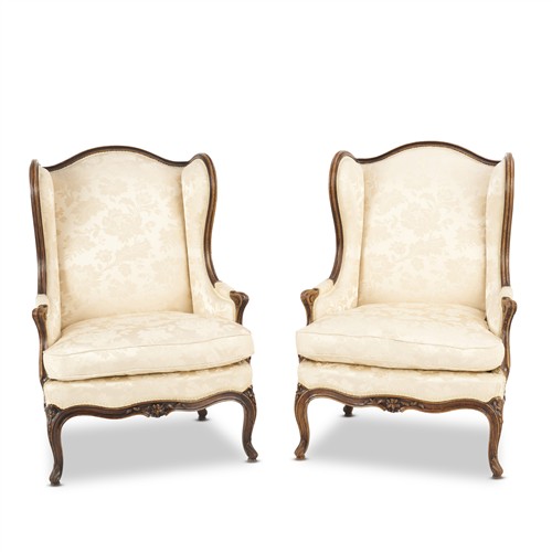 24 · A PAIR OF PROVINCIAL LOUIS XV-STYLE STAINED BEECH AND UPHOLSTERED BERGERES À OREILLES Late 20th century, each impressed 'Emile Vasseur