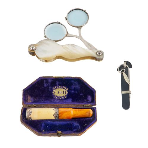 74 · A MOTHER OF PEARL HANDLED SET OF SILVER FOLDING SPECTACLES, A CASED CIGAR HOLDER WITH SILVER MOUNTS, AND AN ART DECO BAKELITE AND WH...