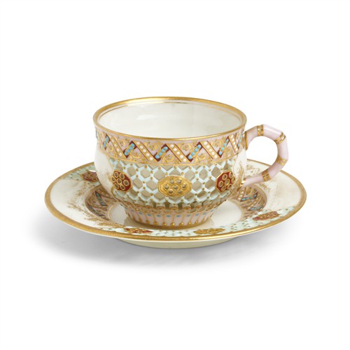 A ROYAL WORCESTER PORCELAIN DOUBLE-WALLED RETICULATED CUP AND SAUCER IN THE MANNER OF GEORGE OWEN Date cipher for 1882