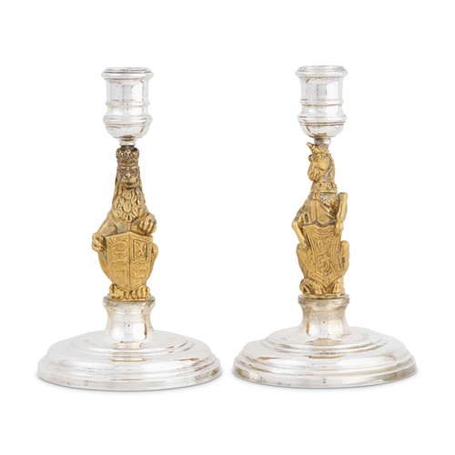 5 · A CASED PAIR OF ELIZABETH II PARCEL-GILT STERLING SILVER 'THE QUEEN'S BEASTS' CANDLESTICKS Garrard & Co Ltd, London, 1977, from a li