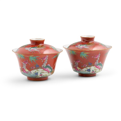 14 · A RARE AND FINE PAIR OF CHINESE RUBY RED-GROUND FAMILLE-ROSE BOWLS AND COVERS, DAOGUANG PERIOD (1821-1850), XIEZHU ZHUREN ZAO HALL M...