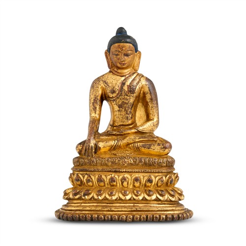 87 · AN INDIAN GILT-BRONZE SEATED FIGURE OF BUDDHA, POSSIBLY PALA PERIOD, 14TH CENTURY