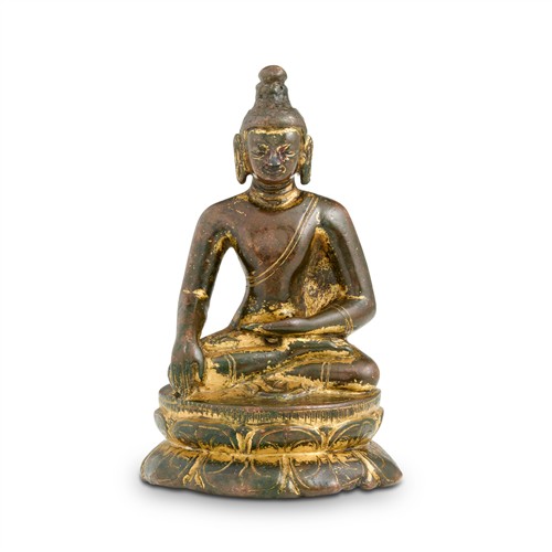 84 · A RARE NEPALESE GILT-BRONZE SEATED FIGURE OF BUDDHA SAKYAMUNI, 10TH/11TH CENTURY