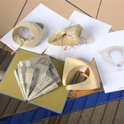 A COLLECTION OF FOUR PAPER SCULPTURES WITH ACCOMPANYING EXHIBITION IMAGES