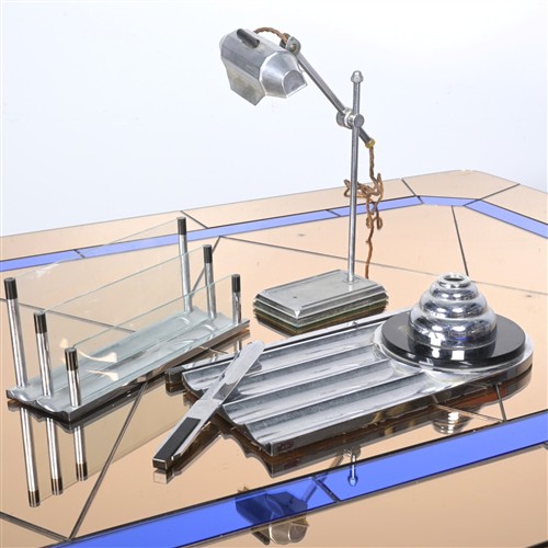 AN ART DECO OFFICE DESK SET INLCUDING AN INKWELL TRAY, CHROME AND GLASS MAIL SORTER, ENVELOPE KNIFE AND CHROME DESK LAMP BY PIROVETT...