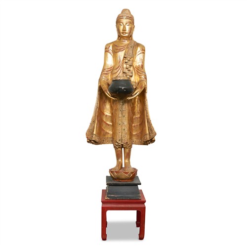 AN ANTIQUE-STYLE SOUTH-EAST ASIAN CARVED AND GILTWOOD FIGURE OF A BODHISATTVA 20th century Please see important information below re...