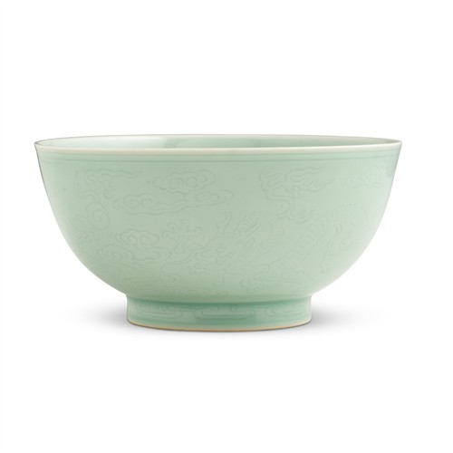 10 · A RARE CHINESE CELADON-GLAZED INCISED "DRAGON" BOWL, KANGXI SIX-CHARACTER MARK IN UNDERGLAZE BLUE WITHIN A DOUBLE CIRCLE AND OF THE...