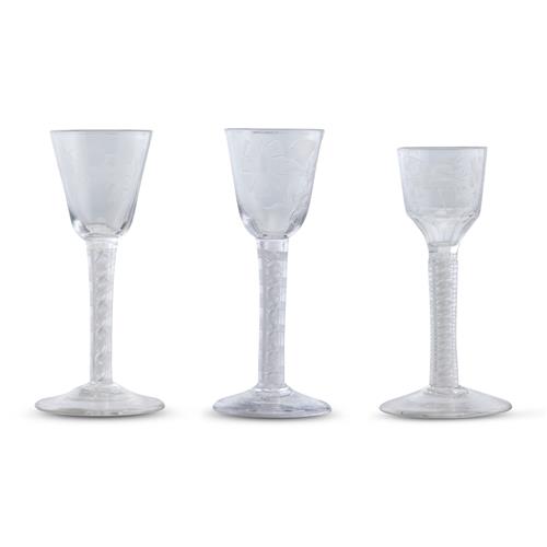12 · THREE GEORGE III OPAQUE TWIST STEMMED WINE GLASSES Third quarter 18th century, circa 1760-1770
