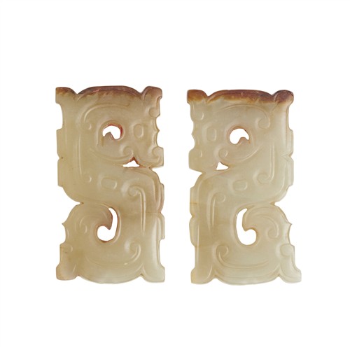 42 · A PAIR OF CHINESE CELADON JADE DRAGON PENDANTS, POSSIBLY WARRING STATES PERIOD