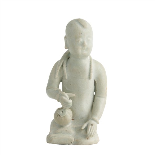 67 · A CHINESE QINGBAI SEATED BOY, SONG DYNASTY (960 - 1279)