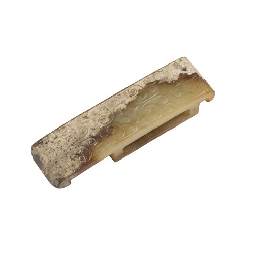 50 · A CHINESE CELADON JADE ‘MASK’ SWORD SLIDE