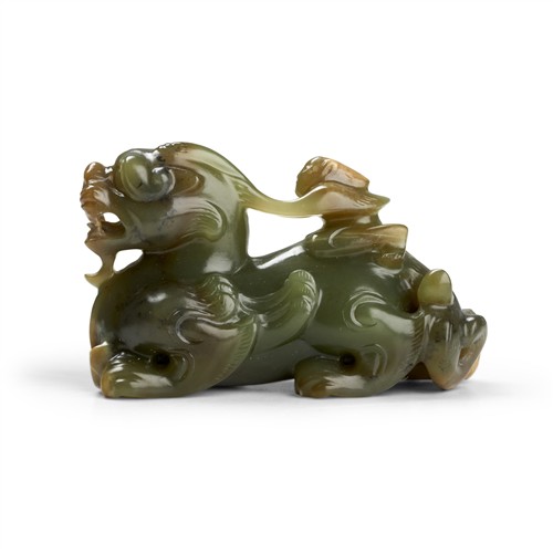A Chinese Celadon Jade Carving Of A Mythical Beast And A Yuren