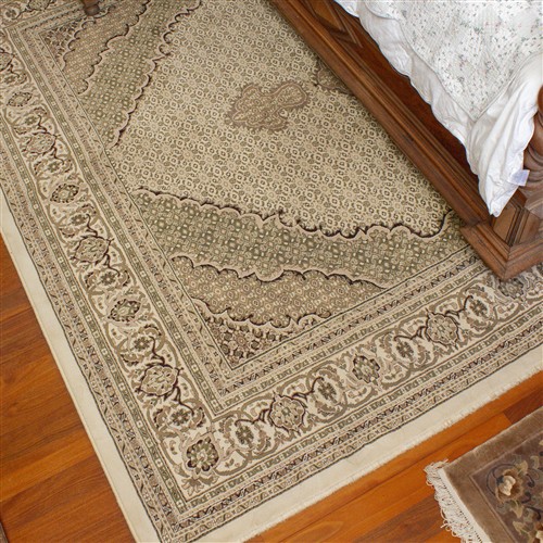 A LARGE CREAM AND BROWN TURKISH RUG