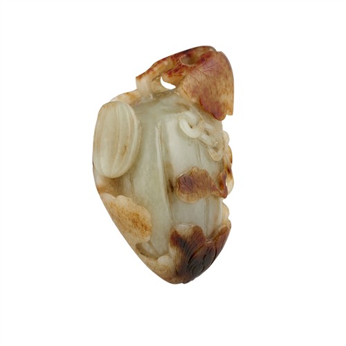 24 · A CHINESE CELADON AND RUSSET JADE CARVING OF A MELON, QING DYNASTY (1644 - 1911)
