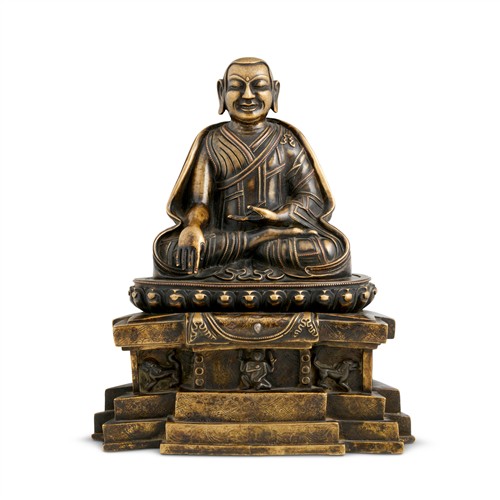 70 · A LARGE AND FINE TIBETAN IRON AND SILVER - INLAID BRONZE SEATED FIGURE OF A LAMA, POSSIBLY 14TH CENTURY