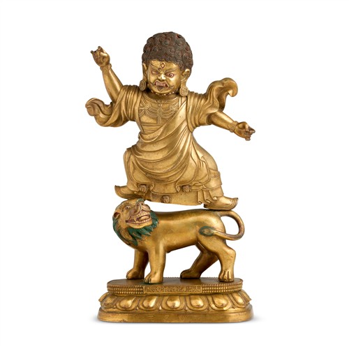 65 · A SINO-TIBETAN GILT BRONZE STANDING FIGURE OF ACALA AND A LION, QIANLONG MARK, 18TH/19TH CENTURY