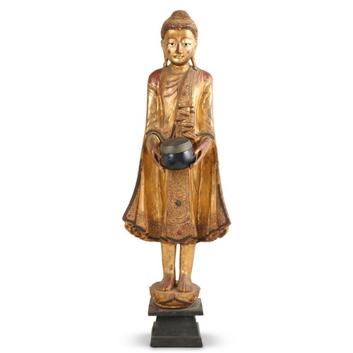 AN ANTIQUE-STYLE SOUTH-EAST ASIAN CARVED AND GILTWOOD FIGURE OF A BODHISATTVA 20th century Please see important information below re...