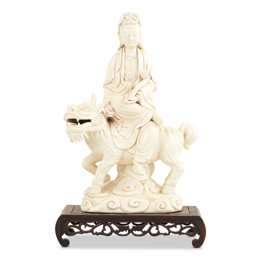 69 · A DEHUA STYLE PORCELAIN FIGURE GROUP OF GUAN YIN MOUNTED ON A GUARDIAN LION Please see important information below regarding collect...